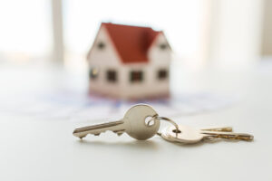 close up of home model, money and house keys